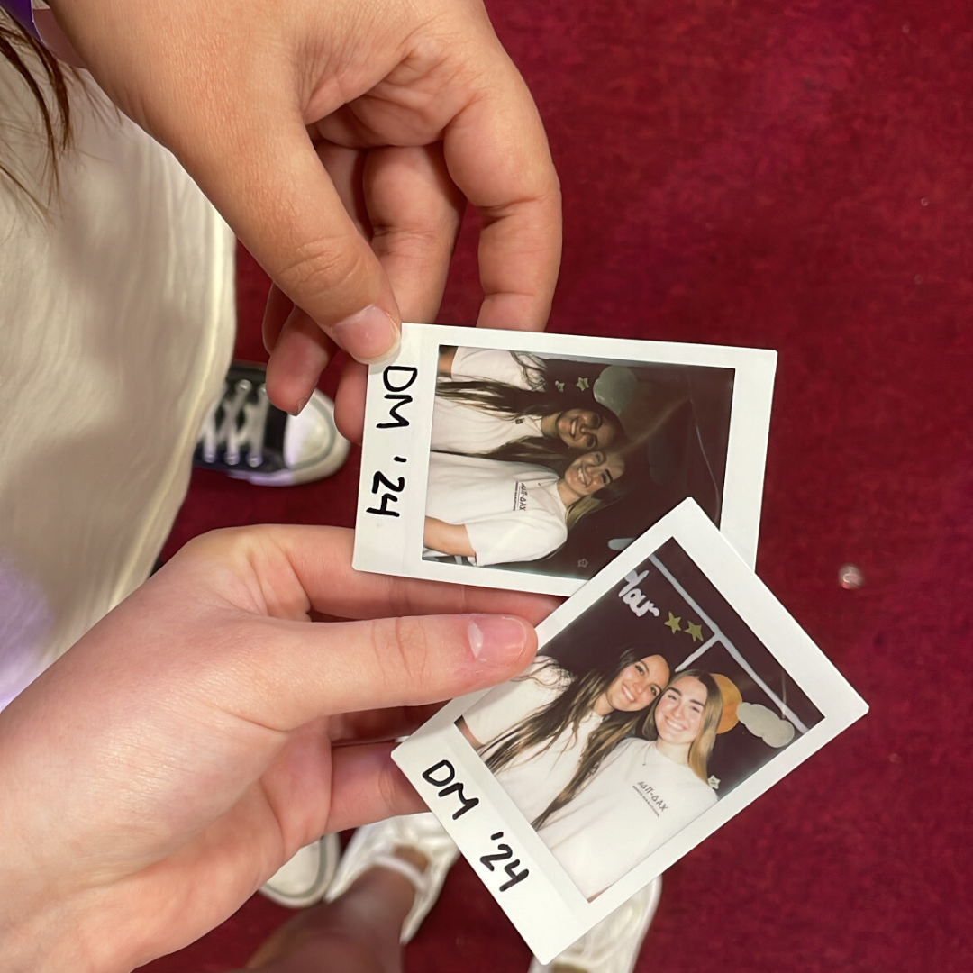 Untitled design (20) dance marathon poloroid pictures in hands from top view